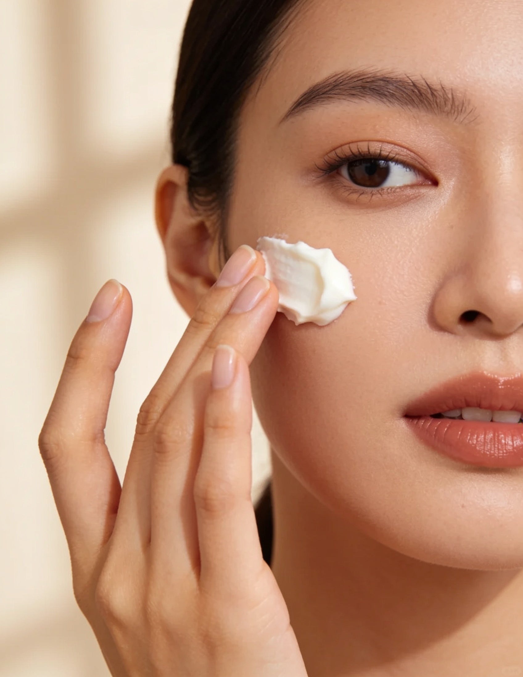 Applying Sanatlyn skincare cream, soft editorial beauty photography