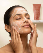 Woman applying Sanatlyn 3-in-1 Face Cleanser with a  product tube in the background