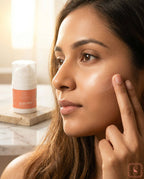 Woman applying Sanatlyn All Day Cream with SPF 30 to her face with a jar of cream in the background