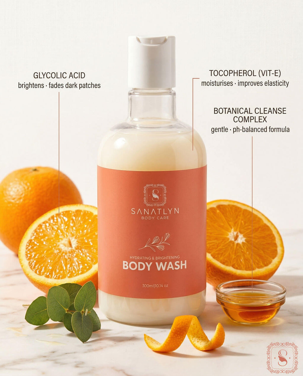 Sanatlyn Hydrating & Brightening Body Wash bottle with oranges and eucalyptus leaves on a marble surface