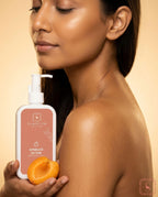 Woman holding a bottle of Sanatlyn Aprikoze Lotion and an apricot fruit against a beige background