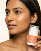 Woman holding a Sanatlyn All Day Cream with SPF 30  product with a neutral background