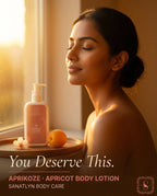 Woman with a bottle of Sanatlyn Aprikoze apricot body lotion by a window.