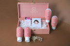 Sanatlyn L'il Luxe Affaire mini skincare gift box products displayed on a wooden stand