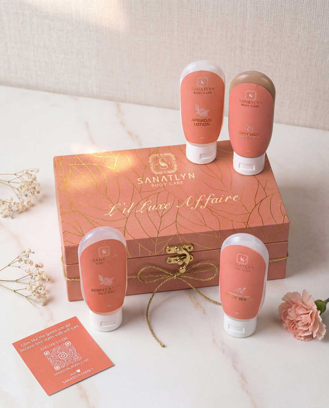 Sanatlyn body care products with a decorative box on a marble surface.