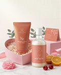 Sanatlyn skincare products including a face wash and body wash with fruits and flowers on a light background