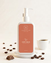 Bottle of Sanatlyn  Coffy Salve  Body lotion  with coffee beans and a cup on a light background