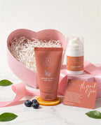 Sanatyn skincare products including a face wash and cream with a pink heart-shaped box in the background.